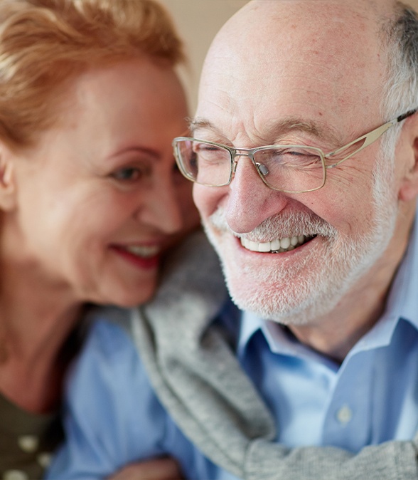 Man and woman laughing together after visiting their Dallas periodontist