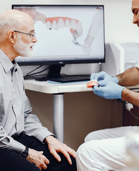Dentist and older man discussing candidacy for All on 4