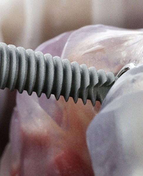 Close up of a dental implant being inserted into a jawbone model