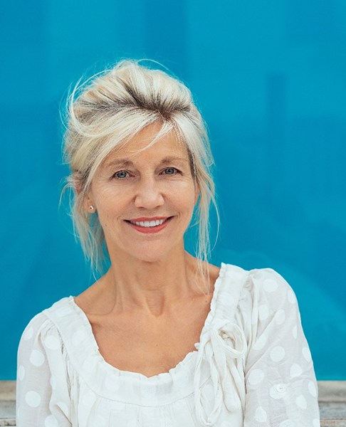 Woman in a white blouse smiling