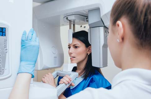Woman getting a cone beam scan of her mouth