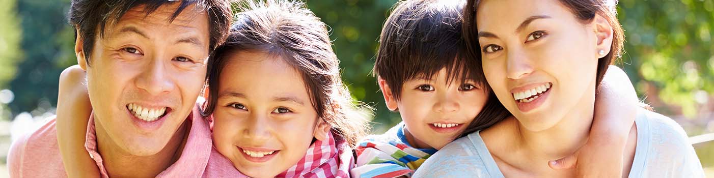 Family smiling after seeing a periodontist near Preston Hollow