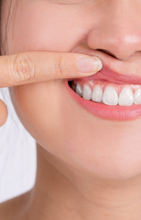 Close up of a man with facial hair and white shirt