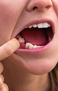 Close up of a woman in a white sweater