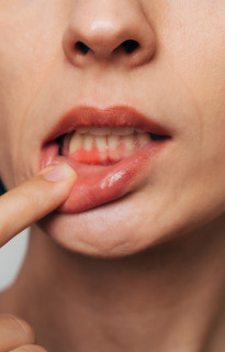 Close up of smiling bearded man with a blue button up shirt