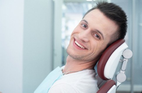 Male periodontal patient looking to the side and smiling
