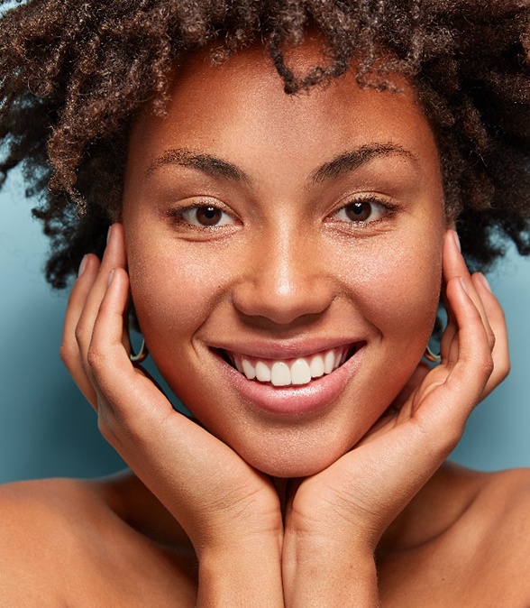 Young woman smiling after gum disease treatment in Dallas