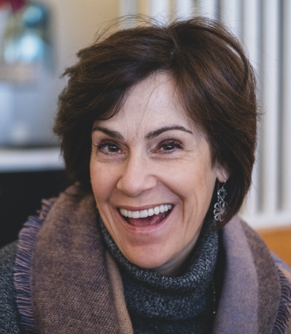 Woman grinning after receiving periodontal services in Dallas