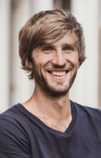 Young man in a dark T shirt smiling