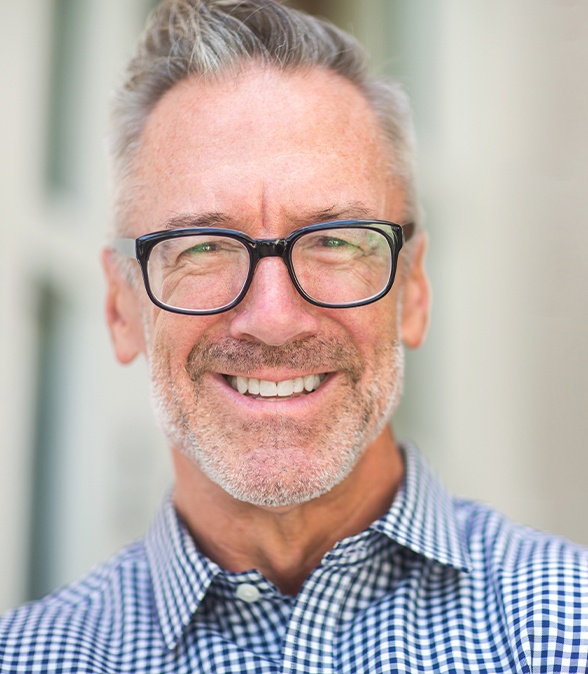 Man smiling after visiting his periodontist in Dallas