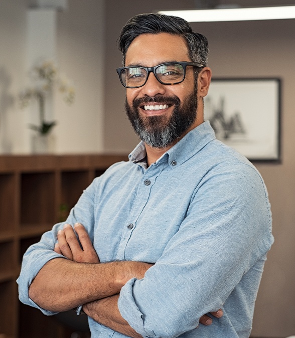 Man smiling and crossing his arms
