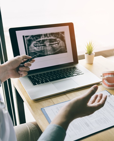 Dentist and patient reviewing digital x rays of teeth
