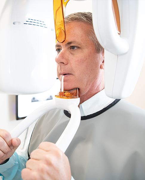 Dental patient receiving 3 D cone beam imaging