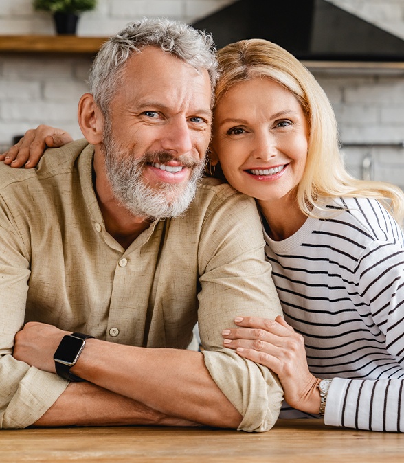 Man and woman smiling after periodontal treatment in Dallas