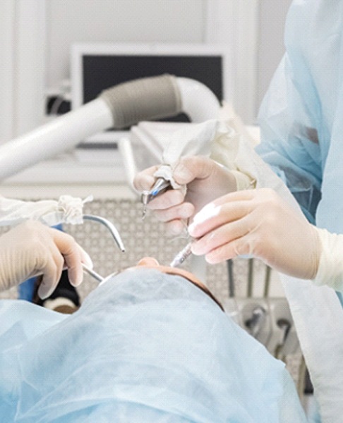 Periodontist performing wisdom tooth extraction