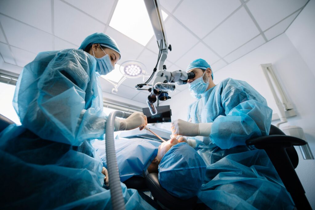 Dentists performing surgery on patient